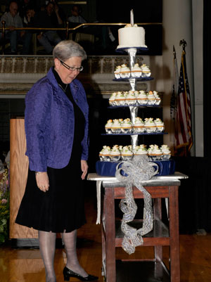 President Davie Jane Gilmour eyes an anniversary cake, prepared by baking and pastry arts students to mark her 10 years at the Penn College helm.