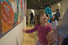 Artist's vibrant work captivates young gallery patron
