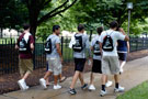 Toting their newly issued backpacks, members of a PFEW contingent follow admissions representative Lynn M. Yeager