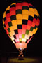 Tethered hot-air balloon provides a colorful nighttime tableau