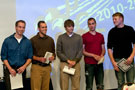 Men's volleyball players stand to be recognized