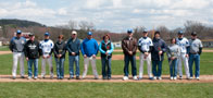 Baseball coach Chris Howard, left, joins his graduating seniors Ryan Weachock (21), Ryan Herrmann (in blue warmup), Brett Braker (13) and Ethan Boyd (12) and their families prior to a weekend doubleheader