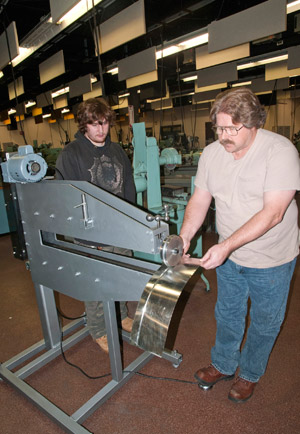 %0AStudents Calvin D. Ferrin, of Mount Airy, Md., and Kirby W. Haskell, of Nescopeck, both enrolled in a Fixture Design and Fabrication course, demonstrate the operation of a bead roller the class produced. The oversized roller will be used by students in the college%E2%80%99s new automotive restoration technology major.