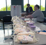 Volunteers prepare collection bags for blood donors