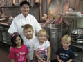 Barbara A. Hanford, assistant cook, and some of the children from the Birds