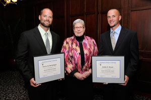 Travis M. Breininger, left, and Justin H. Bentz, right, receive congratulations from Penn College President Davie Jane Gilmour for their Alumni Achievement Awards.