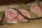 Hundreds of handmade pink roses decorated this rustic cake