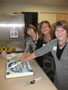 From left, Barbara J. Albert, program specialist, early childhood education; Billie A. Coffman, associate professor of early childhood education; and Nancy A. Grausam, assistant professor of education/early childhood education; cut the cake celebrating the program's accreditation