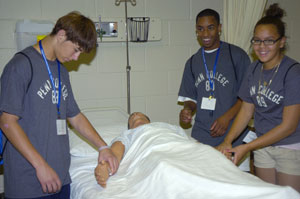Camp Coca-Cola participants work with a medical manikin in the nursing laboratory at Pennsylvania College of Technology.