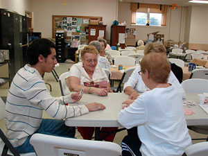 Ibrahim Al-Maiyouf hones his English-speaking skills and learns a new diversion with the help of card-playing South Williamsport seniors.
