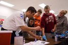 Andrew Capone shows Career Day participants how to test a person's blood-sugar glucose level