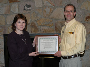 Randy Fetterolf, a corporate recruiter for Cleveland Brothers Equipment Co. Inc., receives a plaque from Mary A. Sullivan, dean of natural resources management at Pennsylvania College of Technology, acknowledging the company%E2%80%99s 15-year participation in the Caterpillar Excellence Fund.