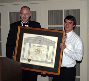 Sigma Nu Vice Regent Duane H. Dreger presents the Nu Gamma charter to Ryan M. Enders, the Penn College chapter's commander.