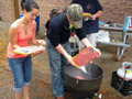 Adding ground beef to the chili pot are Ashley G. Maietta and John P. Bailey
