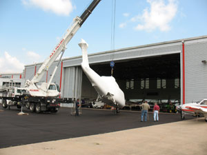 Sheathed in protective covering and destined for years of instructional use, a Sikorsky S-76A helicopter is off-loaded by crane into the hangar at Pennsylvania College of Technology%E2%80%99s Lumley Aviation Center.