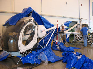 One of two smaller helicopters is unwrapped by students upon its Aug. 24 delivery; aviation majors will perform a limited restoration of the aircraft during course work in Penn College's School of Transportation Technology.