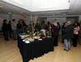 Gallery guests mingle amid attractive refreshments, eye-catching artwork