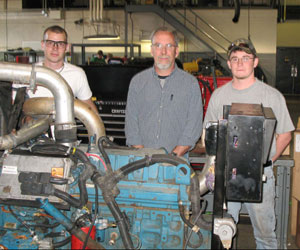 Diesel equipment technology instructor David C. Johnson (center) is joined by electric power generation technology students Benjamin G. Anderson, of Kane (left) and Joshua W. Hagarman, of Hanover.