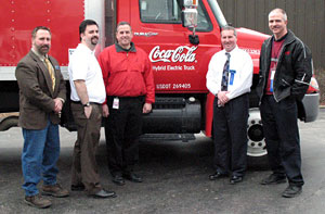 Gathering with the hybrid truck outside the Schneebeli Earth Science Center are, rom left, Mark E. Sones, instructor of diesel equipment technology at Penn College%3B James D. Onufrak, fleet supervisor for Coca-Cola and Williamsport Area Community College graduate%3B Mike Keane, sourcing specialist for Coca-Cola Enterprises in Albany, N.Y.%3B Brett A. Reasner, the college's assistant dean of natural resources management%3B and Rick Reed, also a fleet supervisor.