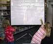 Technology abounded at Madigan Library, where these students danced and saw themselves projected on-screen