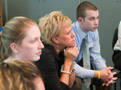 Students listen intently to the perspective of a student colleague