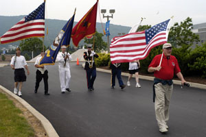A color guard representing varied branches of America's armed forces passes through Pennsylvania College of Technology's main entrance during the annual God, Country and Community Flag March.