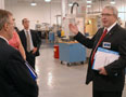 William E. Mack, assistant dean of industrial and engineering technologies, leads guests through the Haas Manufacturing Center in College Avenue Labs