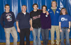Cross country seniors are honored, joined by parents and coach Mike Paulhamus (second from right)