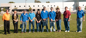 Cross-country runners (in Wildcat blue, from left) Travis Cain, Corvin Oberholtzer and Seth Beckman gather with their parents and coach Mike Paulhamus