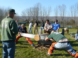 Jack E. Fisher, lab assistant for forestry technology, supervises the men's crosscut-saw competition.