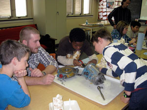 Pennsylvania College of Technology student Zachary D. Ball supervises, from left, Curtin Middle School pupils Dylan Confair, Alex Knauth and Shawn McLeod.