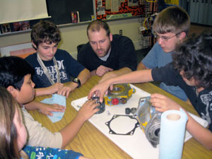 Curtin Middle School youngsters talk %E2%80%9Chydraulics%E2%80%9D with Paul A. Zenga, a diesel equipment technology%2Fheavy construction equipment instructor at Pennsylvania College of Technology, during a recent Brown Bag Lunch program.  From left are Katie Neece, Duta Hariandy, Devin Marty, Zenga, A.J. Baker and Mikale Guinter.