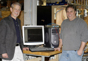 Jack F. Clift, left, vice president%2Fgeneral manager DVL Automation, and Todd S. Woodling, instructor of building automation technology%2FHVAC electrical, with some of the equipment donated to the building automation lab in the Carl Building Technologies Center.