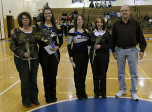 Dance Team seniors Taylor Biery (left) and Adriana Glotz join parents at midcourt