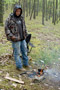 Amazingly maintaining a fire in occasionally heavy wind along a hiking trail, Brent R. Davison, of Clarion, brews an herbal tea made from tree bark