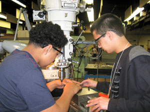 Monroe Career and Technical Institute students Jose Ledesma, left, and Michael Jarvis learn precision machining skills at Pennsylvania College of Technology during an 'Electronics and the Future!' summer camp.