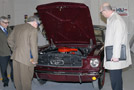 Colin W. Williamson, dean of transportation technology (left), shows off a student-restored 1965 Ford Mustang to Ritchey and Gary Sullivan, vice president of Erie's property and subrogation claims department (right)