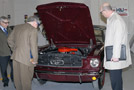 Colin W. Williamson, dean of transportation technology (left), shows off a student-restored 1965 Ford Mustang to Ritchey and Gary Sullivan, vice president of Erie's property and subrogation claims department (right)