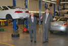 Paul L. Starkey, Penn College's vice president for academic affairs/provost (right) walks Larry C. Backer through the Honda PACT lab
