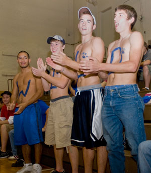Wearing their hearts beyond their sleeves, these body art-adorned fans cheer for the Lady Wildcats volleyball team. (Photo by Jessica L. Tobias, student photographer)