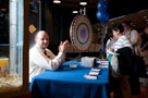 Student Activities' Michael J. Hersh applauds at his table, where free popcorn and a prize wheel drew a crowd