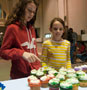 Visitors to the cupcake display take on the difficult task of choosing just one