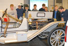 Automotive students greet a 20th-century guest