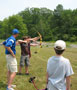 Wildcat archery coach Chad Karstetter works with campers