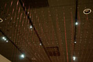 More than 750 pieces of red thread comprise this ceiling-to-floor work
