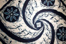 Intricate detail swirls through a textile on exhibit