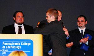 SGA President Brian D. Walton and his incoming successor, Scott M. Elicker, hug after passing the gavel.