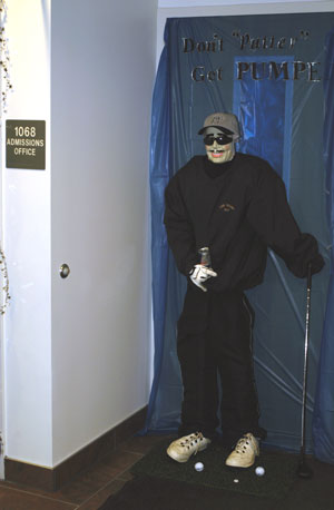 'Don't putter, get pumped' is the message of this manikin - part of a Homecoming display of Penn College Pride - welcoming visitors to the Admissions Office, where Wildcat golf coach Chet Schuman is director.