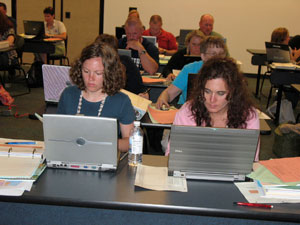 Laura Runyan, left, and Marilee Close, of the Bald Eagle Area School District, work on a plan for incorporating Career Education and Work standards into classroom instruction in their district.