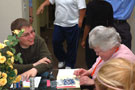 Resident Assistant John C. Phillippy helps a resident with a craft project